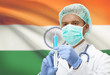 Doctor with syringe in hands and flag on background series - India