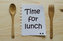 Time For Lunch Written On Note Between Spoon And Fork
