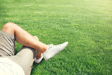 Man Resting Outdoor On A Grass Field