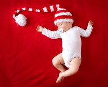 Baby In Red White Knitted Hat