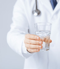 Doctor Hands Giving Glass Of Water