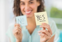 Smiling Businesswoman Holding Yes And No Sticks