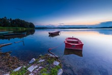 Beautiful Lake Sunset With Fisherman Boat