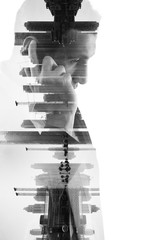 double exposure of business man with mobile phone and city buil