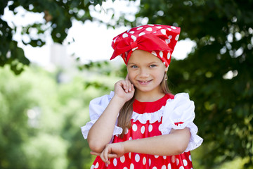 Wall Mural - Portrait of a charming little girl looking at camera