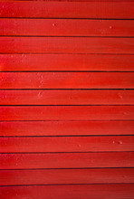 Close Up Of Red Painted Wooden Fence Panels.