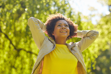 Wall Mural - happy african american young woman in summer park