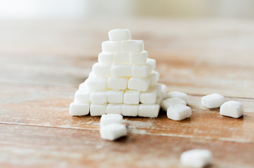 Wall Mural - close up of white sugar pyramid on wooden table