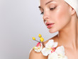 © lenets_tan - Woman in towel with orchid flowers