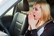 Young blonde student girl panic in a car