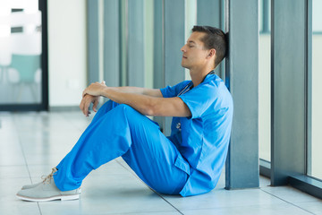 young doctor sitting on the floor