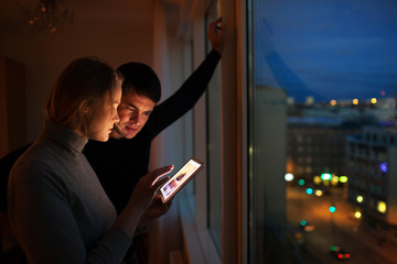 Couple with pad at home in the evening