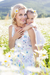 Wall Mural - Family mother and daughter in a field of daisy flowers