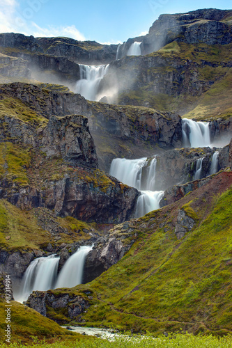 Naklejka dekoracyjna The Klifbrekkufossar waterfall in the Mjoifjordur in Iceland