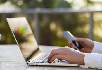 Aufkleber - businessman working with laptop and cell phone