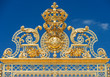 Golden ornate gates of Chateau de Versailles over blue sky, Pari
