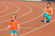 © ruslimonchyk - Mother & little daughter running around the stadium. Child runs away from mom at the stadium.