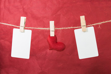 Blank  photo and red  hearts hanging on rope ,valentine  backgro