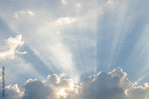 Naklejka ścienna Sunbeam over cloud on sunny day