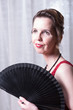 © Jürgen Hüls - attractive woman in red dress hiding behind fan