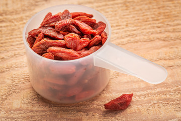 Canvas Print - goji berries in measuring scoop