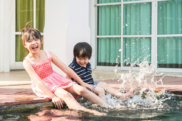 Asian children splashing around