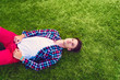 © Tijana - Young man lying on the grass, enjoying