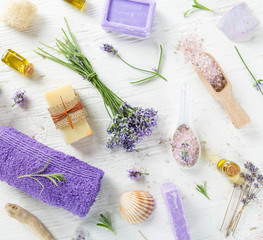  Wellness treatments with lavender flowers on wooden table. Spa still-life.