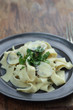 Pappardelle with white clamshells in white sauce.