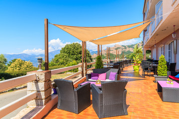 Wall Mural - Chairs with tables in traditional restaurant on coast of Corsica island near Piana village, France