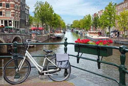 White Bicycle on a Bridge Overlooking a Canal in Amsterdam against Blue Sky Canvas