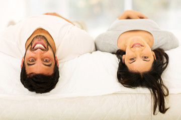 Wall Mural - young indian couple lying on bed