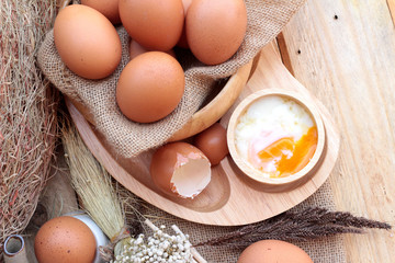 Wall Mural - soft-boiled egg and eggs on wood background