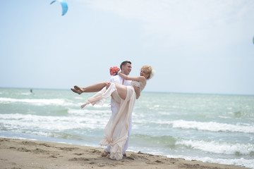 Wall Mural - Smiling wedding couple on beach