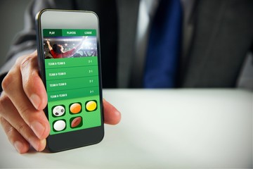 Poster - Composite image of businessman using smartphone