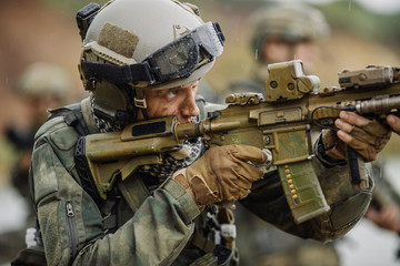 Wall Mural - Portrait of a ranger in the battlefield with a gun