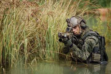 Wall Mural - Portrait of a ranger in the battlefield with a gun