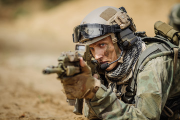 Wall Mural - Portrait of a ranger in the battlefield with a gun