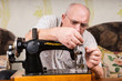 © kolotype - Senior man using a sewing machine