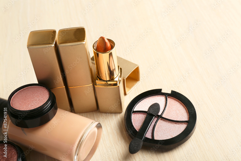 Set of decorative cosmetics on wooden table background