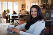 © heebyj - Indian woman with coffee at a cafe