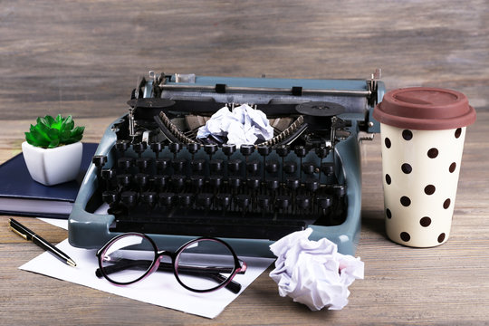 Retro typewriter on wooden background