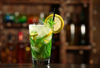 Canvas Print - Glass of cocktail in bar on bright blurred background