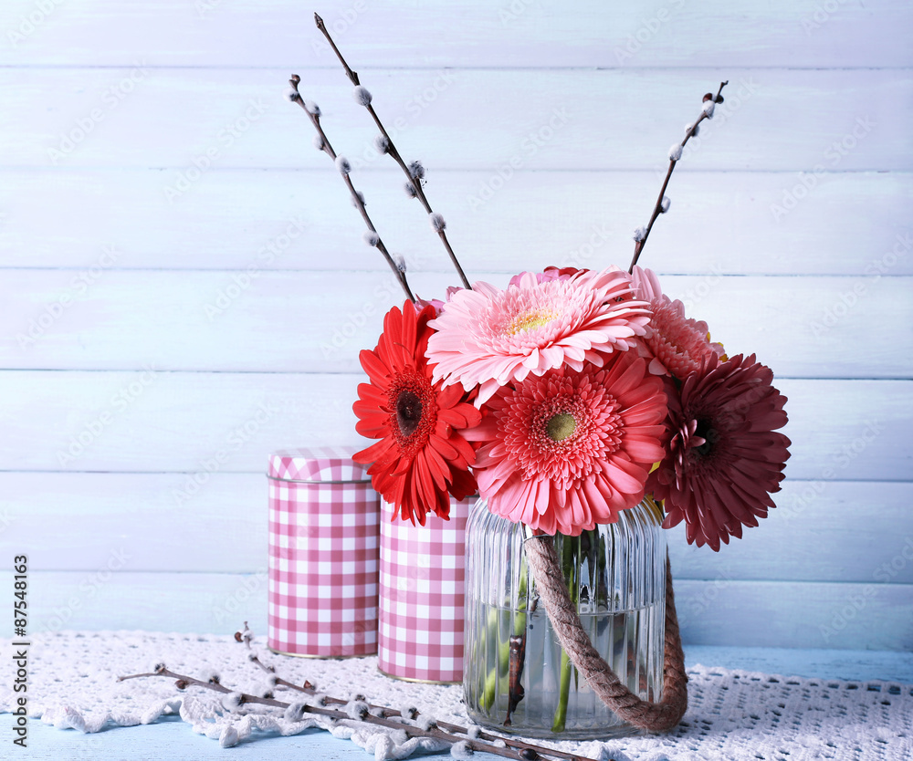 Beautiful bright gerberas in vase on wooden background