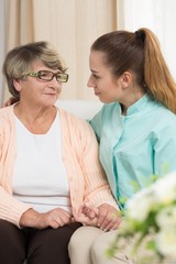 Wall Mural - Elderly female sitting beside nurse