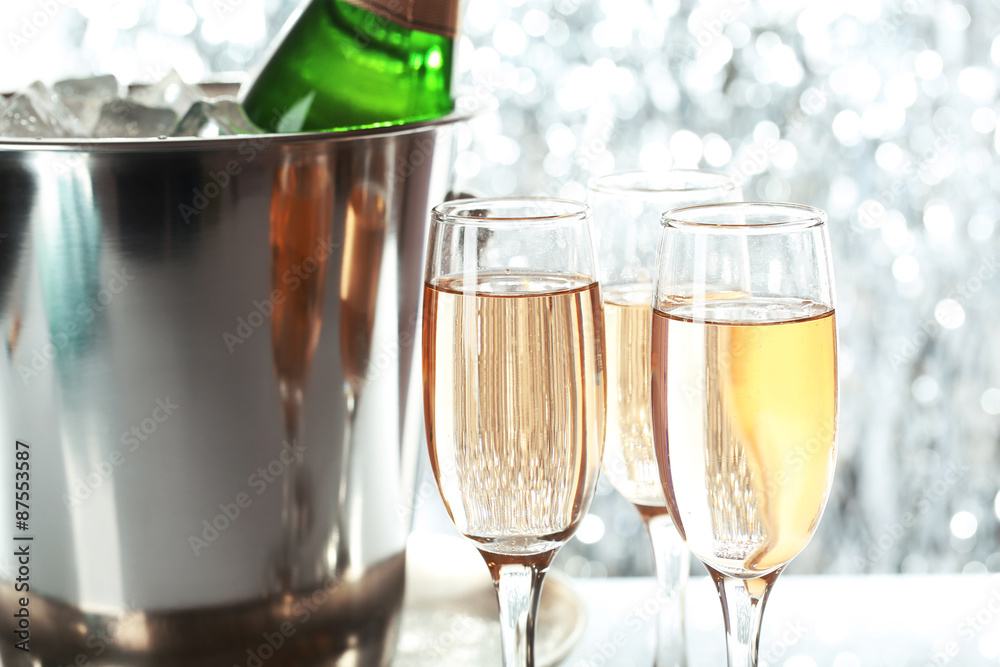 Glasses of champagne on bright background