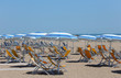 sunbeds with umbrellas in sunny beach in summer