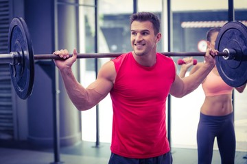 Wall Mural - Two young Bodybuilders doing weightlifting