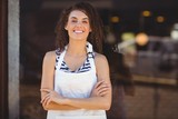 Fototapeta  - Smiling waitress with arms crossed