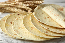 Stack Of Homemade Whole Wheat Flour Tortilla On Cutting Board, On Wooden Table Background